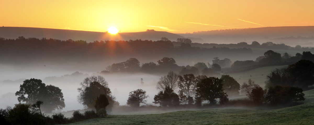 Sunrise over rolling landscape